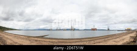 Moored oil rigs off the village of Cromarty on the Cromarty Firth, Ross and Cromarty, Black Isle, Scotland Stock Photo