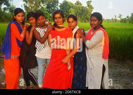Close up of six teenage girls wearing traditional colorful dress posing for the camera, selective focusing Stock Photo