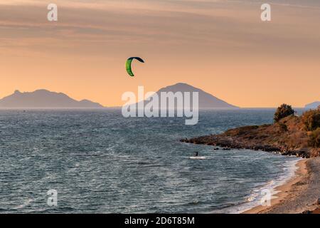 Kite surfing in the sea at sunset in beautiful beach in the island. Stock Photo