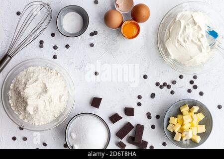 Top view creative arrangement of different products prepared for baking and placed on white clean table Stock Photo