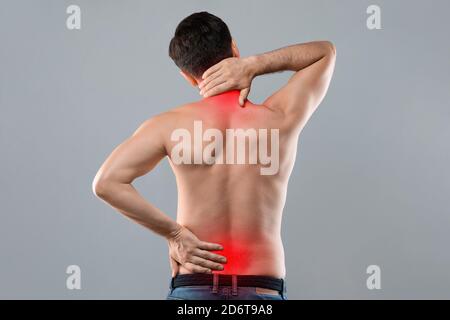 Man holding his hands behind his back Stock Photo