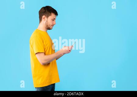 Portrait of young man using his mobile phone Stock Photo