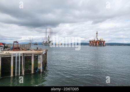 Moored oil rigs off the village of Cromarty on the Cromarty Firth, Ross and Cromarty, Black Isle, Scotland Stock Photo