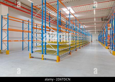 Gravity Flow Rack Shelving in Distribution Warehouse Stock Photo