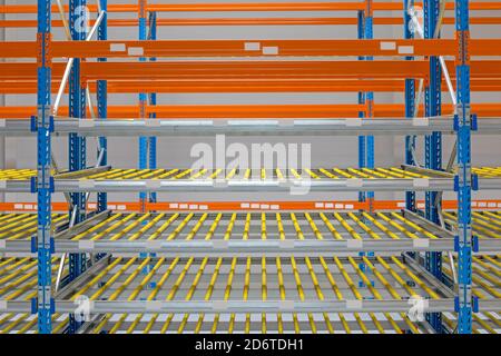 Gravity Flow Rack Shelving in Distribution Warehouse Stock Photo