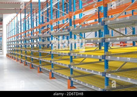 Gravity Flow Rack Shelving in Distribution Warehouse Stock Photo