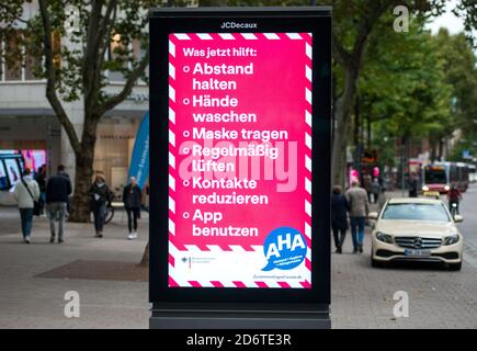 Hamburg, Germany. 19th Oct, 2020. Corona distances and hygiene rules are displayed on a neon sign in the city centre. Hamburg has exceeded the warning level of 50 new infections per 100,000 inhabitants in seven days during the corona pandemic. Credit: Daniel Bockwoldt/dpa/Alamy Live News Stock Photo