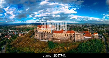 Aerial view of medieval castle on mountain in small european city in autumn season. Panorama of Palanok castle, Mukachevo, Ukraine Stock Photo