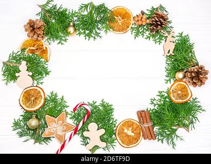 Christmas frame with fir tree branches, oranges, gingerbread cookies Stock Photo