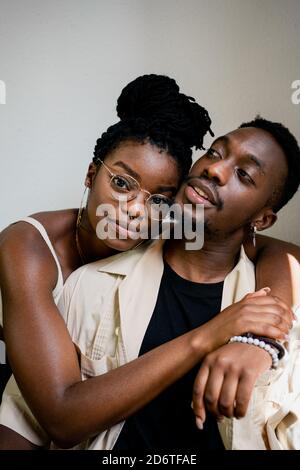 Cheerful young african american husband looks at tired sad wife ...