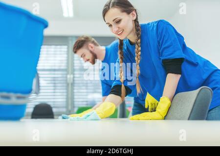 Cleaning crew wiping desks Stock Photo