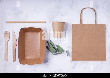 Eco friendly tableware and packaging flat lay. Paper bag, cup and other. Place for text or logo Stock Photo