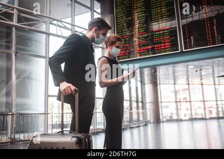 Man and woman checking their boarding passes before the departure Stock Photo