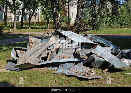 Old rusty sheets of roofing iron in a landfill after renovating a residentia l building Stock Photo