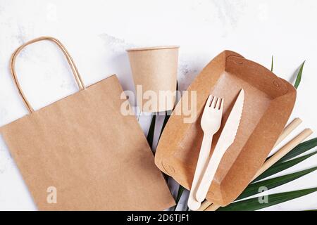 Eco friendly craft paper tableware. Paper cup, bag, fast food container and wooden cutlery. Stock Photo