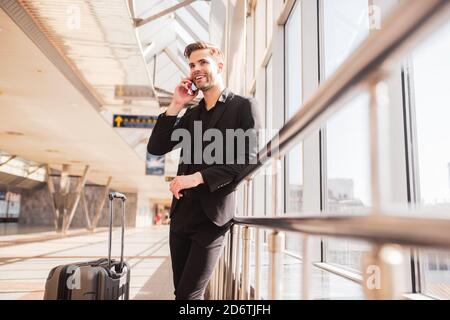 Man making a phone call from the airport Stock Photo