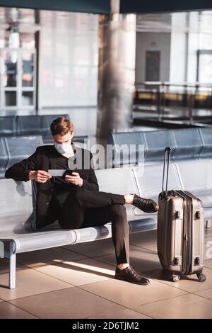 Man cheching his boarding pass before the departure Stock Photo