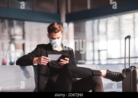 Man checking his ticket before the departure Stock Photo