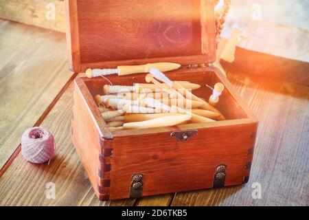 Box with spinning reels. Coil retro with coiled spindle for distaff Stock Photo