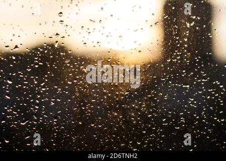 raindrops on the window glass, sunset, evening in the city Stock Photo