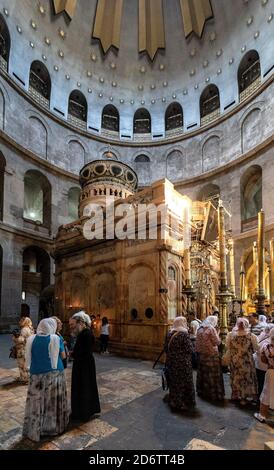 Jerusalem / Israel - 2017/10/12: Church of the Holy Sepulchre interior with pilgrims at Aedicule or Holy Sepulchre chapel in Rotunda in Old City Stock Photo