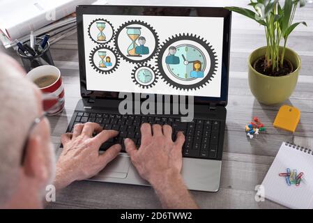 Time management concept shown on a laptop used by a man Stock Photo