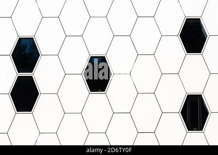 Hexagonal modern architecture background, cell, cells, honeycomb black and white, hexagon shape wall and windows, abstract composition, net Stock Photo