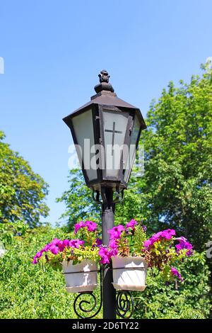 Lantern with a cross on the glass, near the church Stock Photo