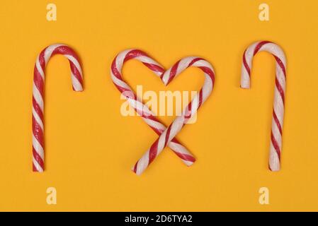 Candy cane heart and canes on a yellow background Stock Photo