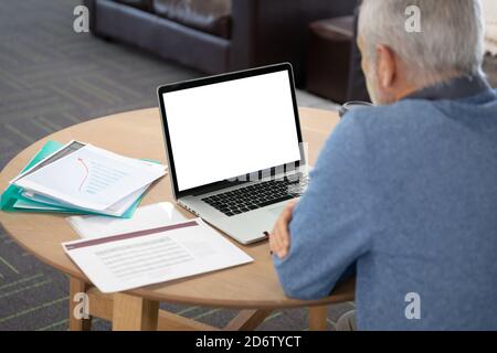 Senior businessman using laptop at modern office Stock Photo