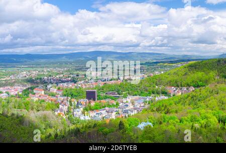 Karlovy Vary city aerial panoramic view with row of colorful multicolored buildings and spa hotels in historical city centre. Panorama of Karlsbad town and Ore mountain range, Czech Republic Stock Photo