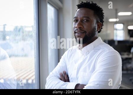 Portrait of Businessman standing near window at modern office Stock Photo
