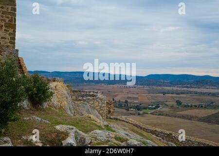 View from castle of farm fields and mountains in the background Stock Photo