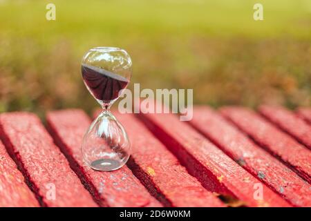 Hourglass on wooden surface with copyspace, vertical photo orientation Stock Photo