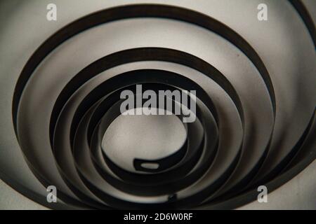 Black metal spiral on white background Stock Photo