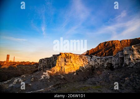 Coal mountain waste with blue sky and evening light Stock Photo