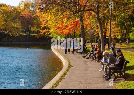 Montreal, CA - 19 October 2020: People enjoying a warm and sunny day at La Fontaine Park in the Autumn season Stock Photo