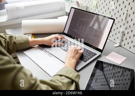 Close up of unrecognizable young woman using laptop while sitting at desk , copy space Stock Photo
