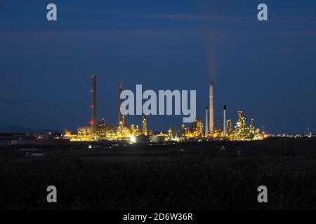 Pembroke oil refinery at night, across from Milford Haven, Pembrokeshire, Wales Stock Photo