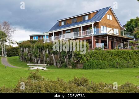 AUCKLAND, NEW ZEALAND - Jun 01, 2019: View of house with terrace and green grass Stock Photo