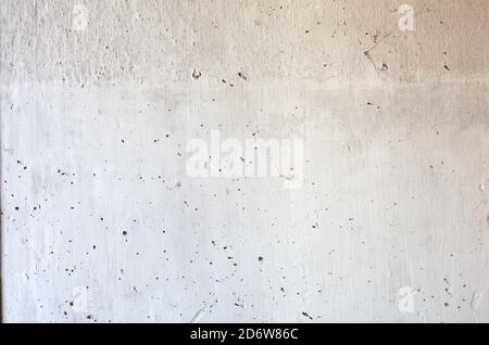 Vintage brick wall with white plaster texture. Background of whitewashed wall indoors. Close-up of white stone wall Stock Photo