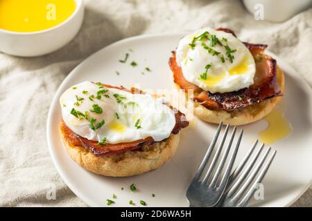 Warm Homemade Eggs Benedict with Ham and Hollandaise Stock Photo