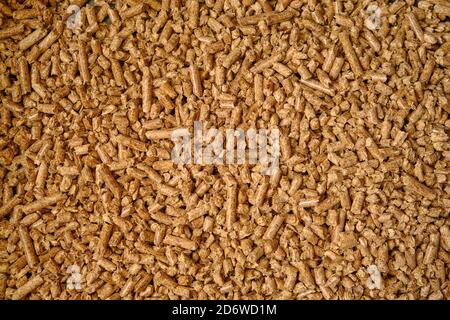 Natural wooden pellets background or pattern. The cat litter. ?lose up natural wood pellet. Ecological heating, renewable energy Biofuels. Top view. Stock Photo