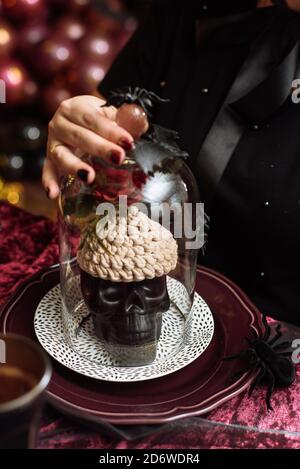 Artificial skull with knitted brains. Halloween decorations. Stock Photo