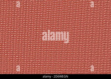 Rough red material with shiny inserts. Texture of fabric curtains with woven metallic threads. Scene curtain fabric background with metal weave. Stock Photo