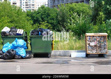 Dumpsters being full with garbage in city. Pollution from trash plastic waste garbage. Stock Photo