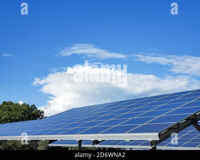Photovoltaic energy panels installed on car parking on sanny day,clean renewable technology Stock Photo