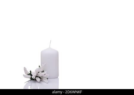 white candle with a sprig of Muscari flower cluster isolated on a white background Stock Photo