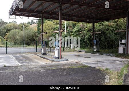 Abandoned gas station with vegetation around it. Spain Stock Photo