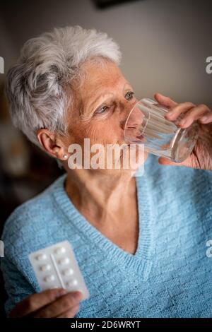 Woman taking medicine. Stock Photo